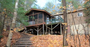 View of the front of the cottage looking up from the lake